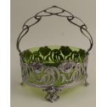 A WMF circular basket, decorated with fret cut flowers and foliage, raised on four splayed feet,