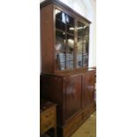 A 19th century mahogany linen press, having two blind panel doors, opening to reveal three slide-out