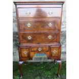 An early 18th century style walnut chest on stand, the upper section having three graduated cross