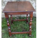 A late 17th century square oak tavern, or lamp, table, with baluster turned legs united by