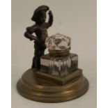 A small bronze ink well, decorated with a boy in period dress, height 5ins