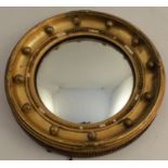 A circular gilt framed convex mirror, with ball decoration, overall diameter 12ins
