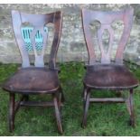 A pair of Arts and Crafts style single chairs, having central pierced vase splat, solid seat, and