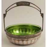 A WMF style circular basket, with fixed handle, having applied floral decoration, with a green glass