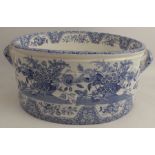 A 19th century Spode blue and white oval foot bath, with moulded body, decorated with urns of