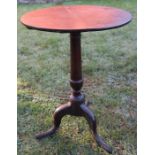 A 19th century oak circular country occasional table, raised on a turned column terminating in a