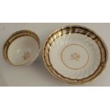A late 18th / early 19th century Worcester 24 flute tea bowl and saucer, with a blue and gilt rim,