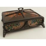 An Art Nouveau style bronze casket, decorated with coloured glass panels, attributed to S Theeman,
