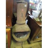 A chimenea, raised on a metal stand, height 49ins