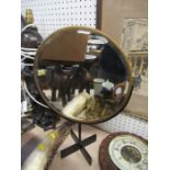 A circular shaving mirror