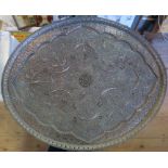 An Eastern metal oval tray, with pierced and embossed decorations, maximum diameter 24.5ins