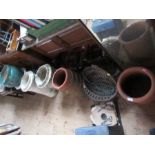 A collection of garden pots to include wrought iron basket, chimney pots, urns, etc.