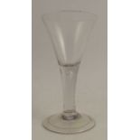 An Antique ale glass, with trumpet bowl, having a tear drop to the stem and a folded foot, height