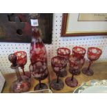 A collection of Victorian ruby glass, to include 7 glasses, a decanter and scent bottle, etched with