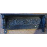 A dark oak over mantel mirror, with carved decoration, 21ins x 60ins