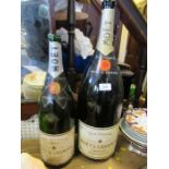Two empty Moet & Chandon bottles, heights 23ins and 19ins