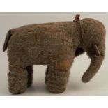 An The ISA Animated Toys elephant, with grey mohair body, black eyes (one missing), wooden tusks,