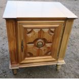 A continental cupboard, with deep relief moulded panel door, raised on a turned legs, width 27.