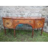 A Regency mahogany bow front sideboard, fitted with a central drawer flanked by cupboard doors,