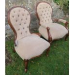 A pair of beech showwood upholstered chairs, on with low arms, both with button backs
