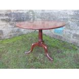 A 19th century mahogany tripod table, raised on a column terminating in three outswept legs,
