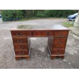 A reproduction pedestal desk, with leather writing top, 47ins x 24ins x height 30.5ins