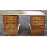 An Edwardian oak pedestal desk, with leather inset writing surface, the pedestals fitted with
