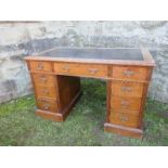 An Edwardian twin pedestal desk, fitted with a central drawer flanked by two short drawers, having