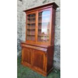A Victorian mahogany glazed cabinet, the upper section fitted with adjustable shelves, over a frieze
