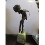 An Art Deco style  painted metal figure, of a dancer with hoop, on an onyx base, height 10.5ins