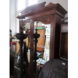 An Edwardian mirror door wardrobe, with carved decoration, width 47ins x height 83ins