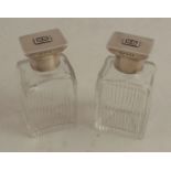 A pair of Art Deco cut glass scent bottles, with sterling silver screw tops monogrammed ‘P B’,