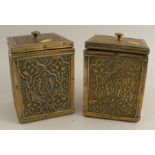 A pair of Arts and Crafts style square brass covered tea caddies, decorated with scrolls and