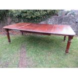 A 19th century mahogany extending dining table, raised on four tapering turned legs, with leaf