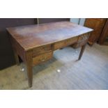 An early 20th century oak desk of rectangular form, fitted with one central drawer above a kneehole,