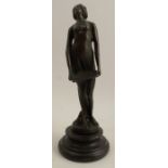 A bronze figure, of a semi-naked girl standing holding a book, raised on a circular stepped