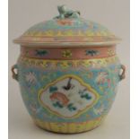 An Oriental covered jar, decorated in pink, turquoise and yellow, height 7.5ins - Good condition