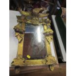 A Regency design gilt wall mirror, decorated with an eagle and swags, mirror plate 14ins x 7.5ins