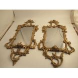 A pair, left and right, of Chippendale style gilt wall mirrors, decorated with A symmetric scrolls