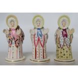 Three Gamp porcelain candlesnuffers and stands, two stands marked Stevenson and Hancock Derby