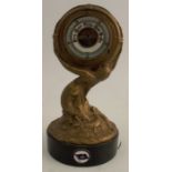 A maritime themed gilt brass aneroid barometer, raised on a wooden base, modelled as a mermaid