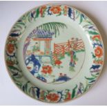 An 18th century Chinese plate, decorated in colours with figures in landscape, diameter 9ins -