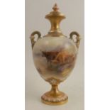 A Royal Worcester covered pedestal vase, decorated to the front with Highland cattle in landscape by