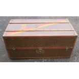 Aux Etats Unis, Paris, a leather and wooden cabin trunk, with red and yellow band, initialled BB,