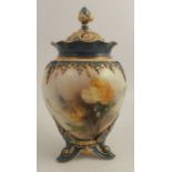 A Hadleys Worcester covered vase, decorated with yellow roses, raised on three feet, height 7ins -