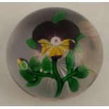 A 19th century Baccarat paperweight, with encased pansy, possible small striation, but difficult
