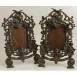 A pair of early 20th century cast iron photograph frames, with copper finish, modelled with