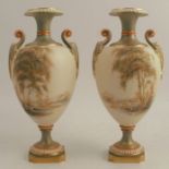 A pair of Royal Worcester pedestal vases, decorated with landscapes of trees, water and mountains,