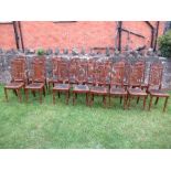 A set of 16 continental style oak dining chairs, with carved decoration, and pierced splat back,