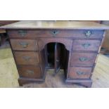 A Georgian oak knee hole desk